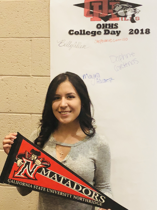 Student holding college banner